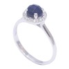 Ring in white gold K14 rosette with natural zircons in the color of sapphire in the center 26234